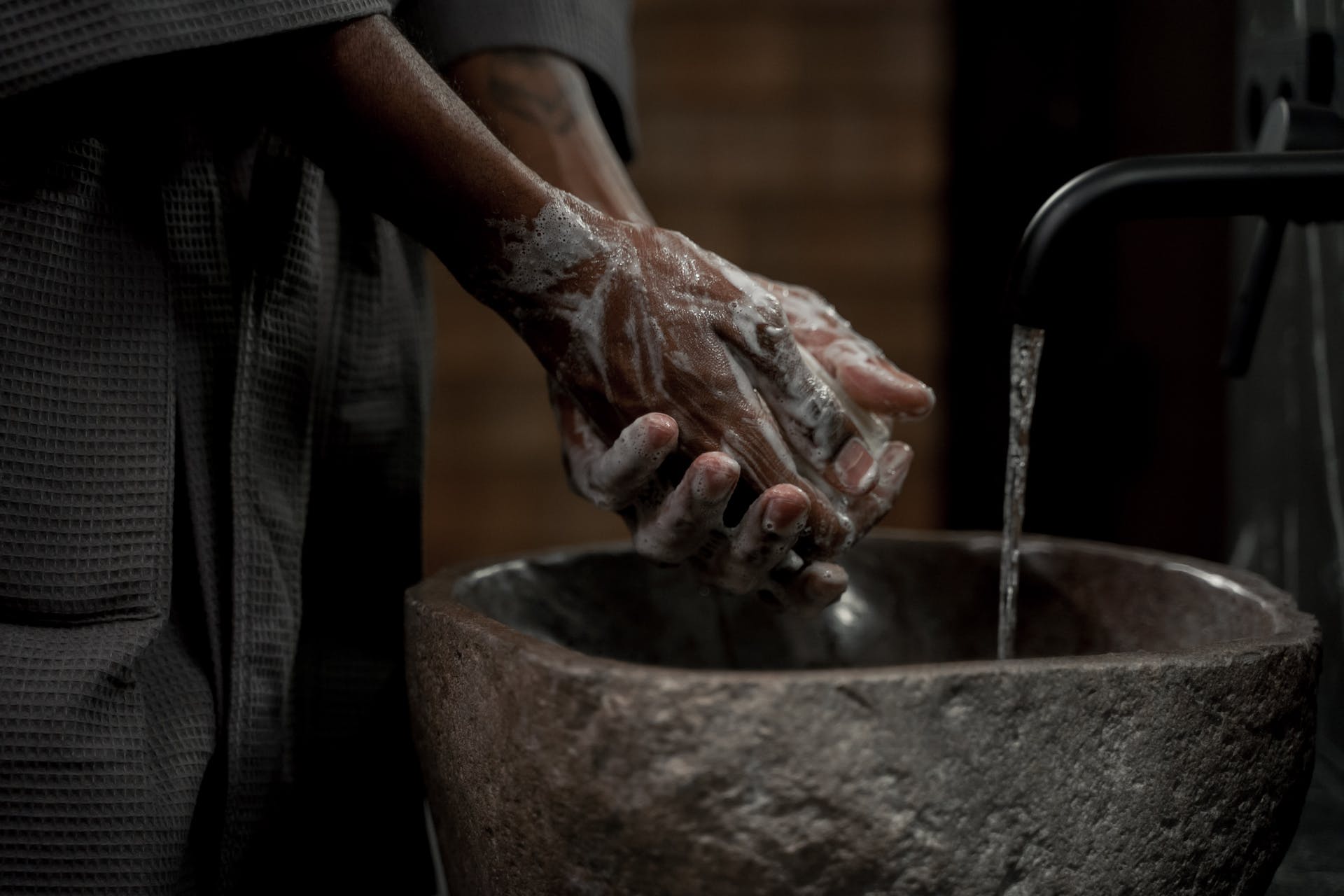 hands being washed woith soap in a sink